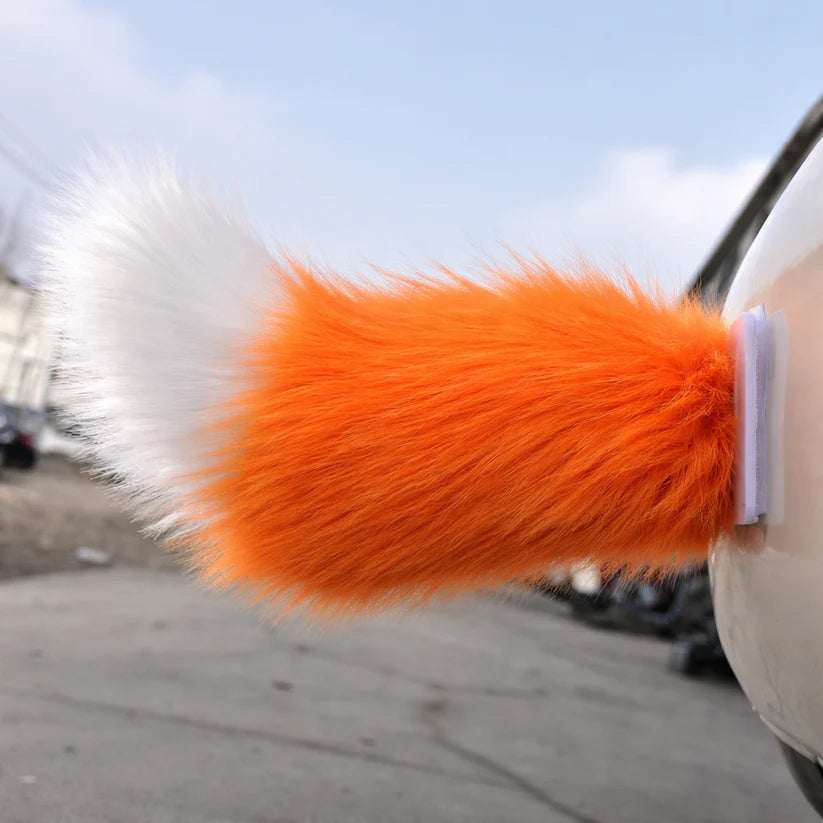 Orange moving tail accessory attached to a vehicle