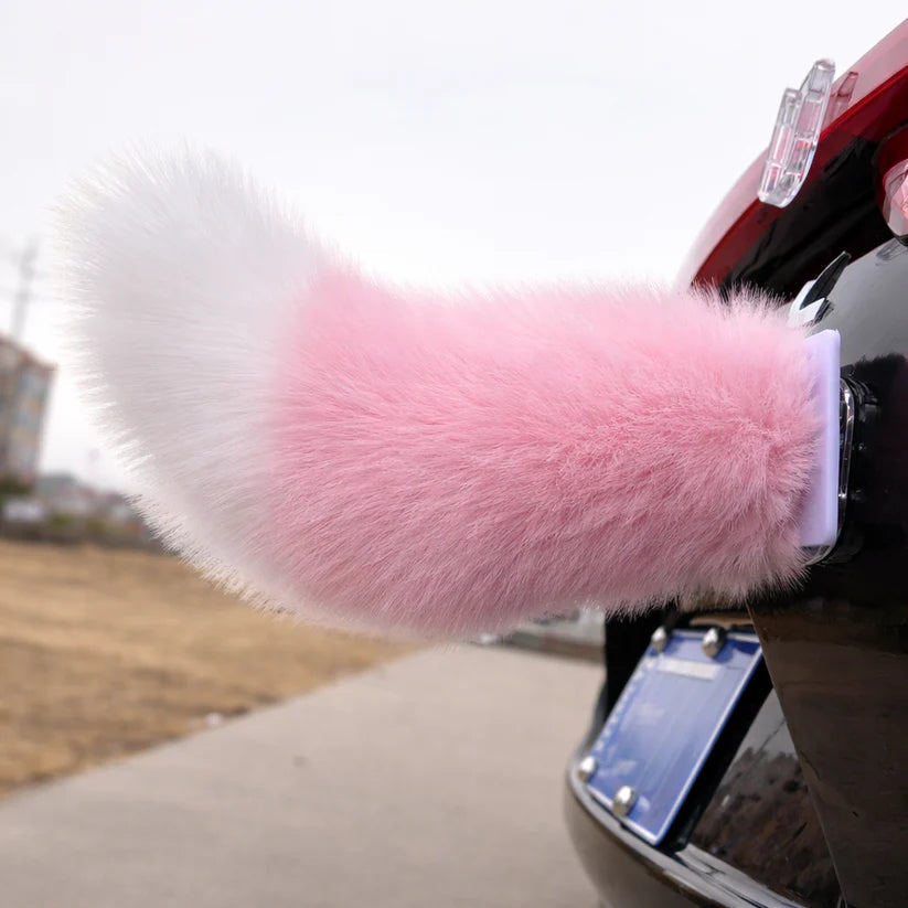 Pink moving tail accessory attached to a car
