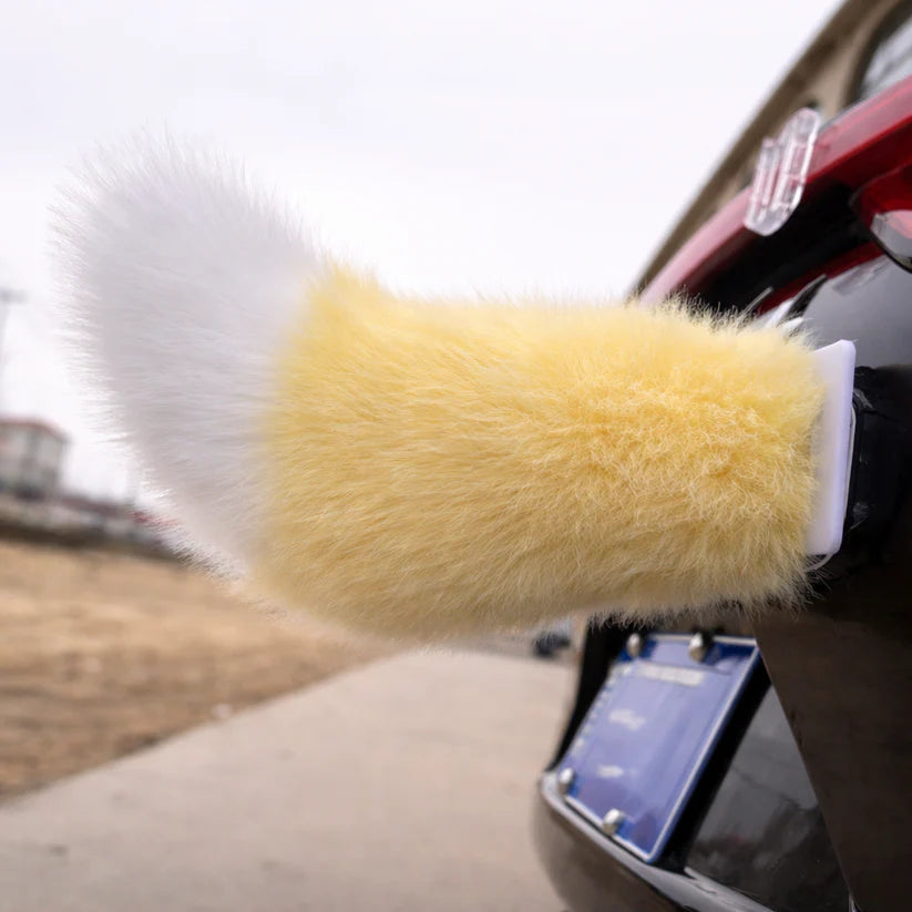 Yellow moving tail accessory attached to a car